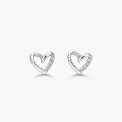 A pair of polished silver heart-shaped stud earrings featuring small cubic zirconia along one side of the heart, with push on butterflies.