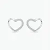 A pair of silver heart-shaped stud earrings featuring small cubic zirconia, set along one side of each heart, with push on butterflies.
