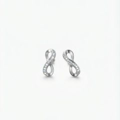 A pair of infinity-shaped earrings crafted from a polished silver-tone metal and is embellished with a delicate row of sparkling cubic zirconia, with push on butterflies.