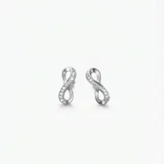 A pair of infinity-shaped earrings crafted from a polished silver-tone metal and is embellished with a delicate row of sparkling cubic zirconia, with push on butterflies.