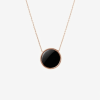 Featuring a polished circular black onyx gemstone set in a rose gold bezel frame, suspended from a matching delicate rose gold chain.