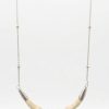 Designer silver necklace featuring a curved, segment-carved bone center piece suspended from a delicate chain with small bead accents.
