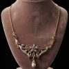 Art Nouveau 18ct yellow and white gold bespoke necklace featuring a central emerald, pave-set diamonds, and a dangling pearl drop.