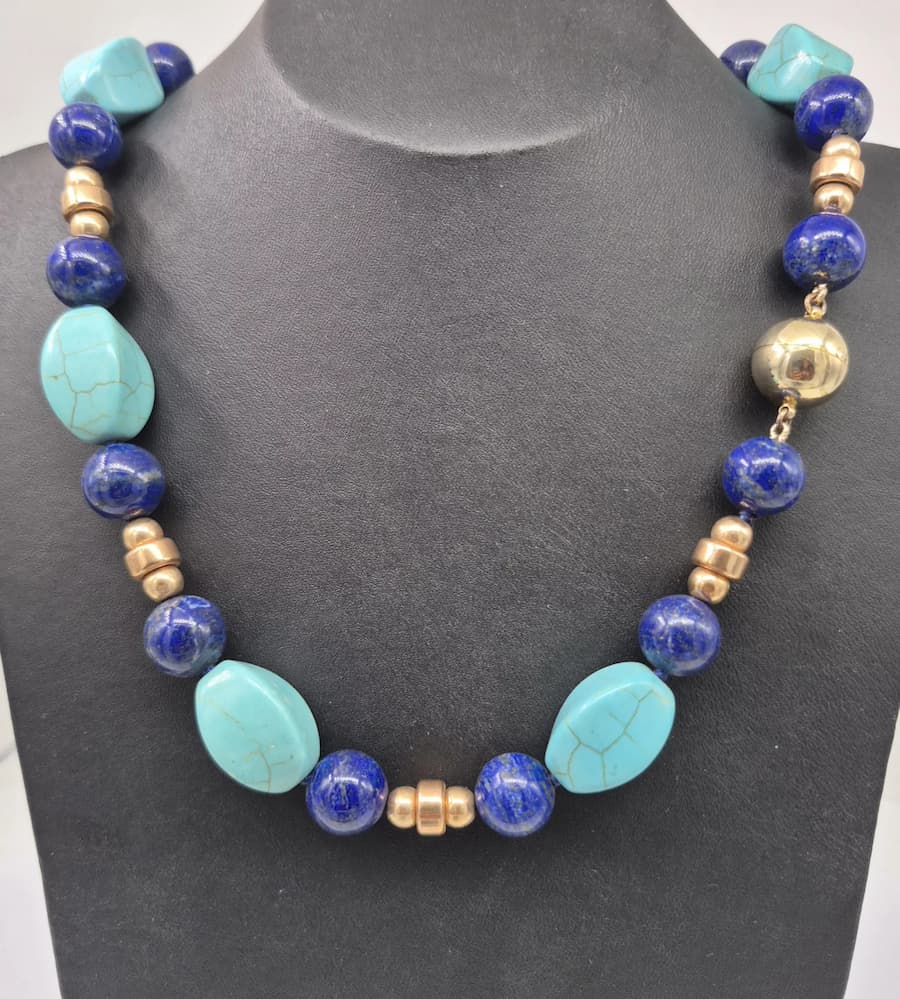 Gemstone necklace displayed on a black background.